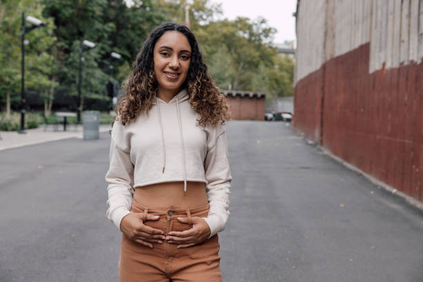 istock Young woman portrait against a red wall 1744742289
