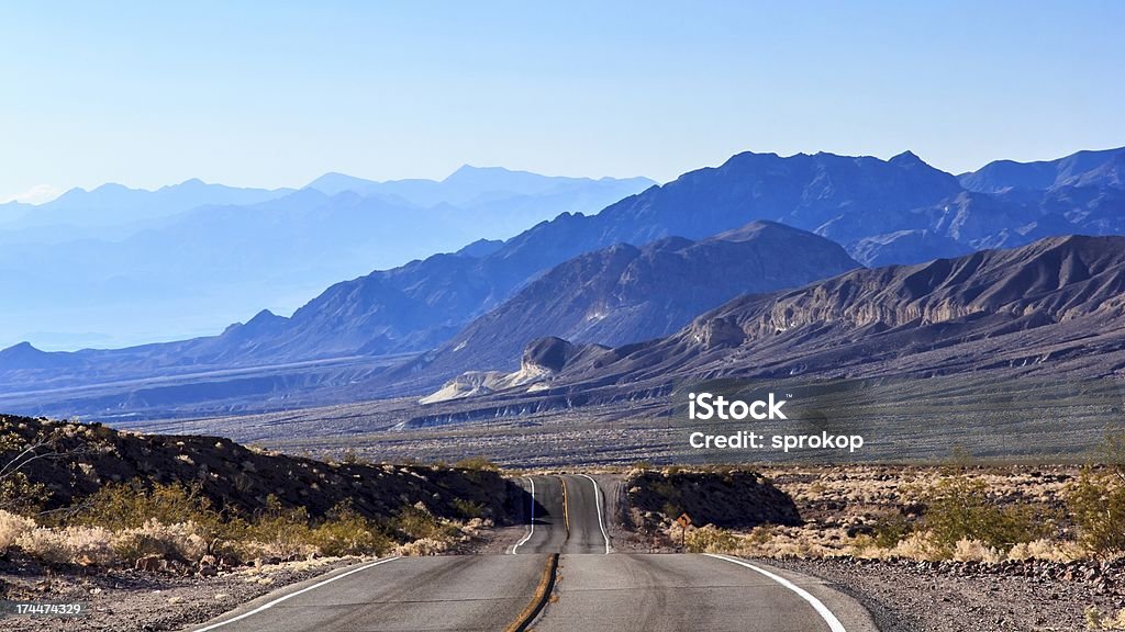 Desert Highway Desert highway across the desert through the mountains at Death Valley National Park Arid Climate Stock Photo