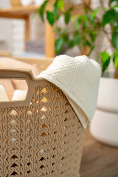 istock Beige plastic basket for laundry in a room 1744745073