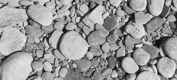 Pattern with rounded pebbles of a beach in black and white. Abstract.  Copy space