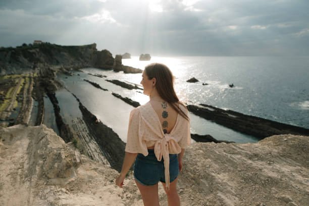 istock Woman by the sea at sunset 1744747048