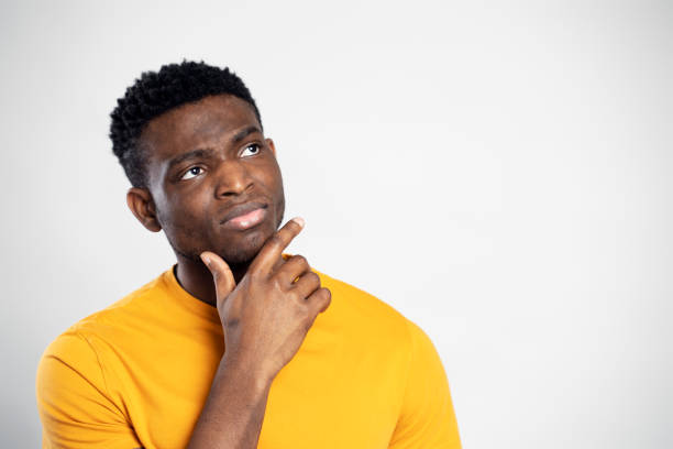 istock African man, pensive student planning something, looking for idea isolated on background. Education 1744747091
