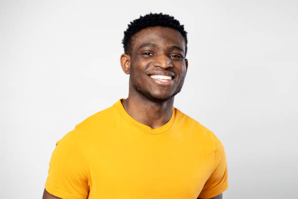 istock Handsome smiling Nigerian student looking at camera isolated on white background. Education concept 1744747095