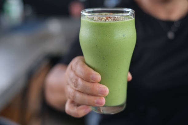 Unrecognizable Person Holding a Cold Green Detox Smoothie