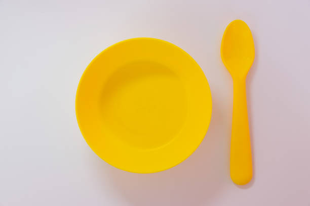 istock Yellow spoon and plate on the white background. 1744749695