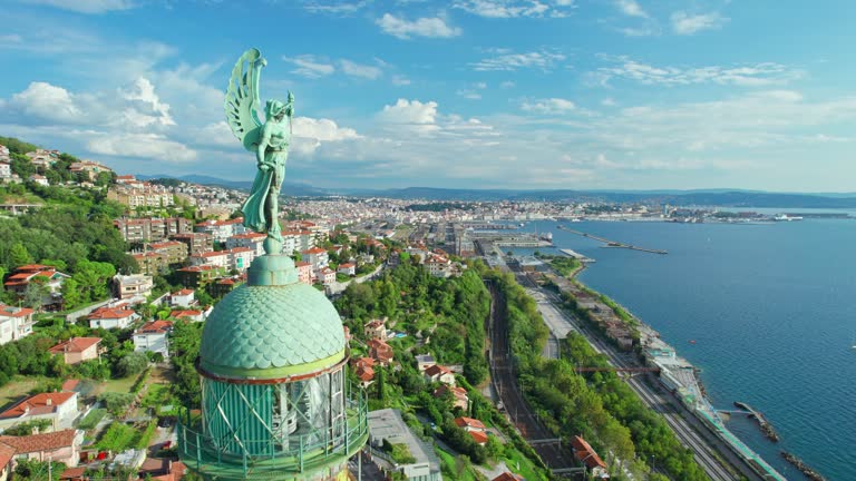 Faro della Vittoria lighthouse in Trieste city at sunny day, Italy