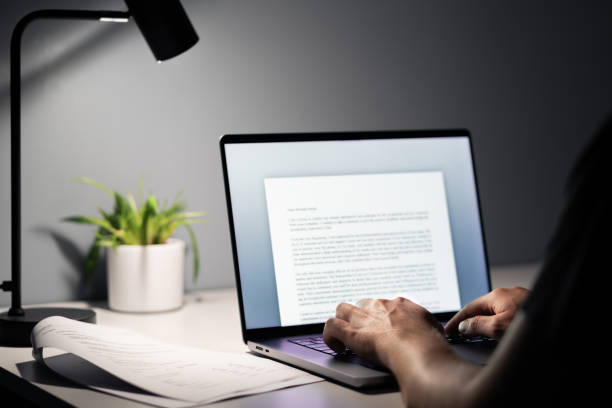 istock Man writing text document, essay or letter with laptop. Freelance writer, journalist or entrepreneur working late at night, overtime. Job seeker, cv resume and application. 1744768965