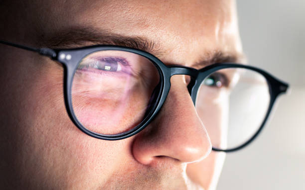 Glasses and eye. Looking at screen. Focus on work. Computer, laptop, phone or tv reflect. Tired squinting eyes. Serious man with poor eyesight and bad vision. Smart geek guy. Glasses and eye. Looking at screen. Focus on work. Computer, laptop, phone or tv reflect. Tired squinting eyes. Serious man with poor eyesight and bad vision. Smart geek guy. Monitor light on face. squint eyes stock pictures, royalty-free photos & images