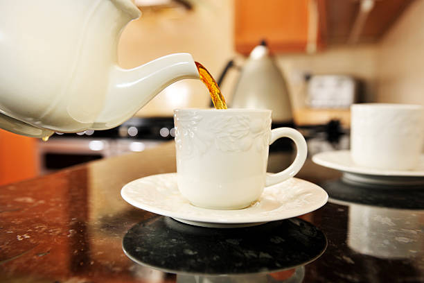istock tea poring from teapot 174477122