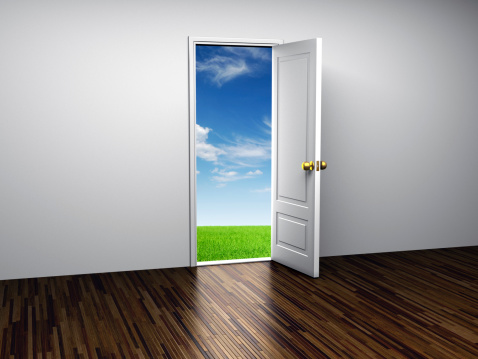Open door with green grass and blue sky on the other side........................................................................................