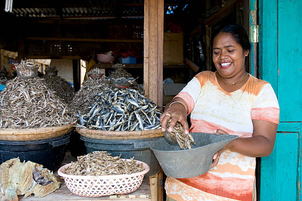 market on sumba - mature woman having fish bildbanksfoton och bilder