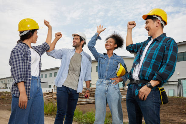 istock group of workers or architect celebrating success at work and project on the construction site 1744780871