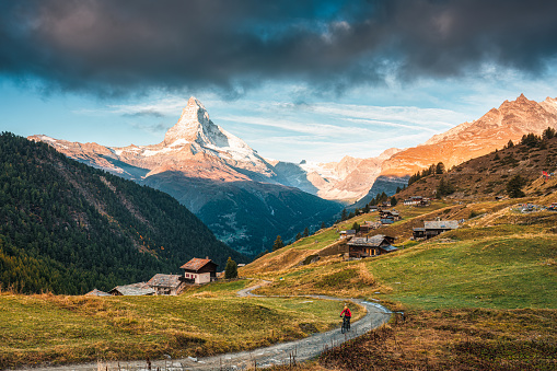 Beautiful landscape of Matterhorn iconic mountain, Swiss alps and small village of wooden huts on the hill in the morning at Zermatt, Switzerland