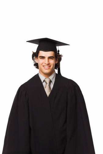 Portrait of a boy in graduation robes isolated on white background