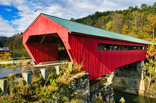 A country road leads to Hunsecker's Covered Bridge spanning Conestoga Creek in Lancaster County, Pennsylvania.