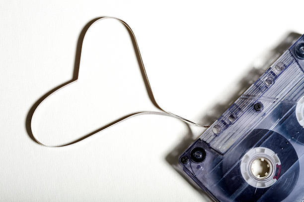 Love Tape Cassette tape with the tape in the shape of a love heart. Great metaphor for giving a mixed tape as a Valentines Day present mix tape heart stock pictures, royalty-free photos & images
