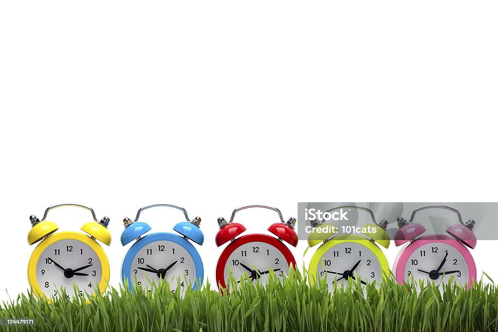 color O'clock and grass Alarm Clock Stock Photo