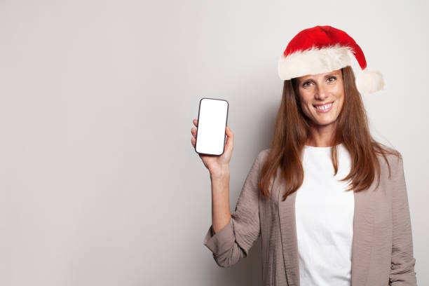 istock Happy mature woman holding modern smartphone with white empty screen 1744803128