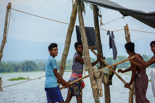 A fisherman's hard work is evident as he casts his net in the heart of Kaptai Lake