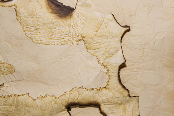 istock Retro torn aged paper. Burnt edges. Burnt paper. Ashes. Scrolls, crumpled paper. Ancient monuments. 1744812165