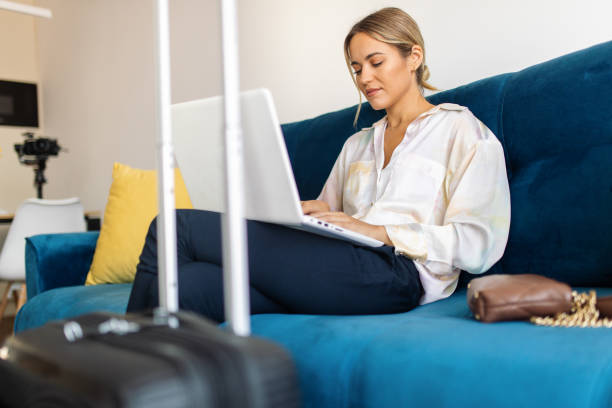 istock Young woman just arrived in rented apartment and using laptop 1744814477