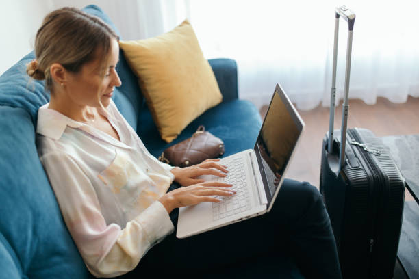 istock Young woman just arrived in rented apartment and using laptop 1744815071