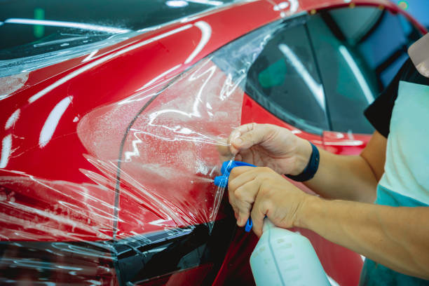 istock The process of installing protective film on the new red car. 1744817862
