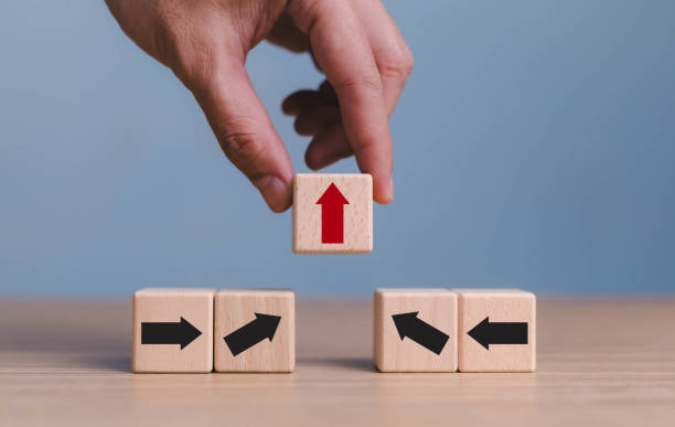 istock Finger pushing red up arrow which it opposite direction from black down arrow, Business concept growth success process, wood block stacking as step. business disruption and leadership concept. 1744821049