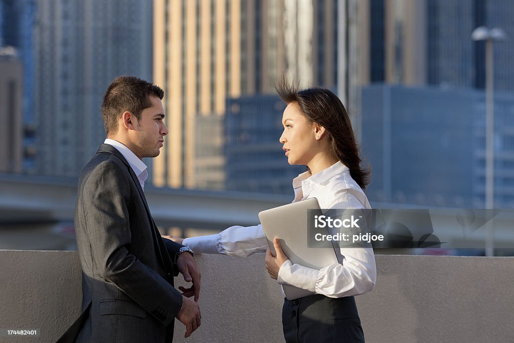 Negócios falar entre homem e mulher de negócios no financial district - Foto de stock de 25-30 Anos royalty-free