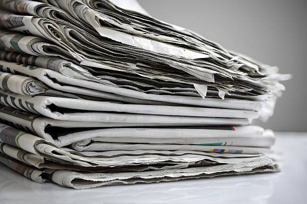 istock Pile of folded newspapers on white 174482750