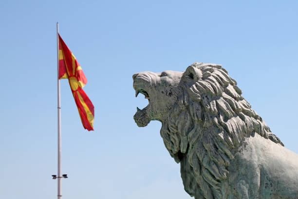 The national macedonian flag and lion sculpture. Skopje, North Macedonia. stock photo