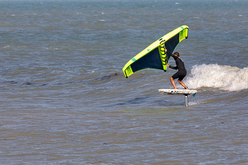 Eastbourne, UK - Aug 21, 2020. A windsurfer surfing in a beach of Eastbourne of East Sussex.