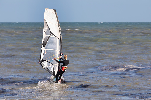 Eastbourne, UK - Aug 21, 2020. A windsurfer surfing in a beach of Eastbourne of East Sussex.
