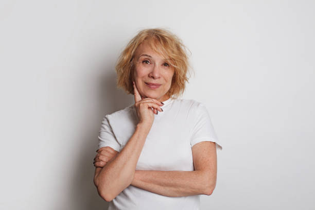 istock Cheerful senior woman smiling standing against white studio wall background 1744842648