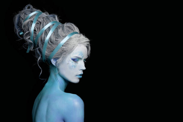 istock Beautiful woman she-devil. Sensual lady with creative makeup on black background 1744842701