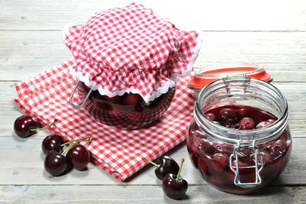 home canned cherries on wooden table