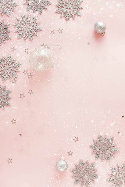 istock Christmas pink background template with copy space top view with silver xmas decor.Beautiful Xmas greeting card mockup.New Year decor frame 1744865703