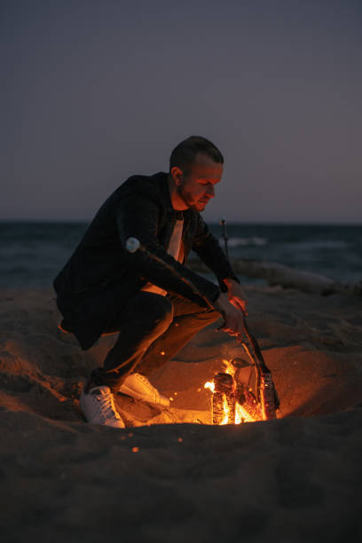 istock Man make a campfire near the sea at evening 1744882797
