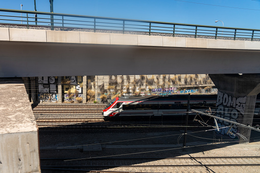 Train of the National Network of the Spanish Railways Renfe passing through an infrastructure at the exit of the Atocha station in the Spanish capital. Madrid. Spain. July 29, 2023.