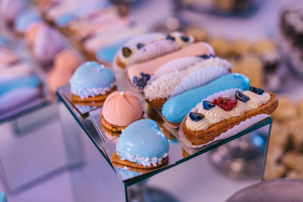 istock candy bar for the holiday, macaroons on the festive table, delicious eclairs fruit decoration 1744891729