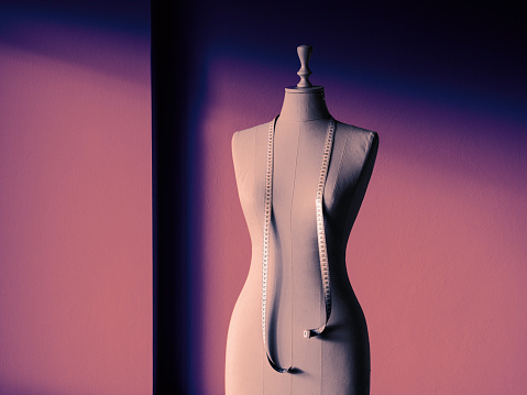 Close-up of female tailor's mannequin with measuring tape.