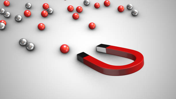 istock Magnet attracting chrome balls business leadership concept 1744895054