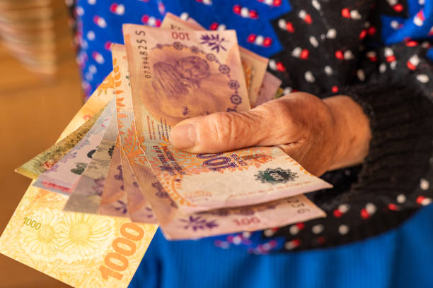 istock Argentinian money, a pensioner holds several pesos banknotes in her hand, Financial problems of seniors, low pensions in Argentina 1744900034
