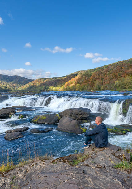 enjoying the view at the breathtaking sandstone falls in new river gorge national park during the fall season in the appalachian mountains of west virginia, usa. - famous place appalachian mountains autumn awe imagens e fotografias de stock