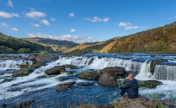 enjoying the view at the breathtaking sandstone falls in new river gorge national park during the fall season in the appalachian mountains of west virginia, usa. - famous place appalachian mountains autumn awe imagens e fotografias de stock