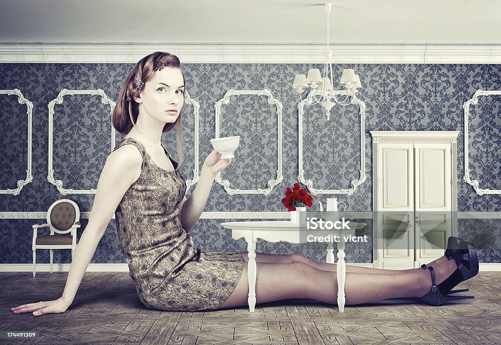 woman in little room beautiful woman in little room drink a cup of tea (concept) Alice in Wonderland - Fictional Character Stock Photo