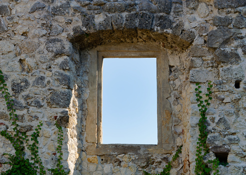 Close-up photo of a window on a stone wall of the ruins of a medieval Samobor Castle on the hill Tepec in the town of Samobor, Croatia