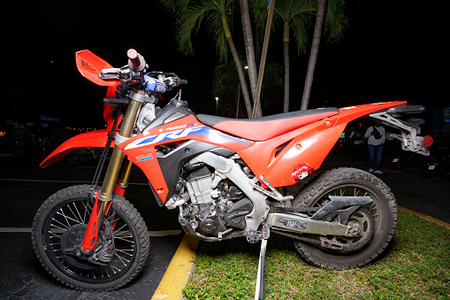 Fort Lauderdale, FL, USA - October 18, 2023: Night flash photo of a red Honda dirt bike motocross