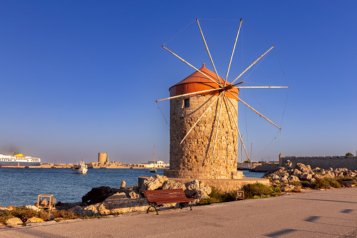 Ancient medieval windmills on the St. Nicholas Pier in Rhodes. Greece.