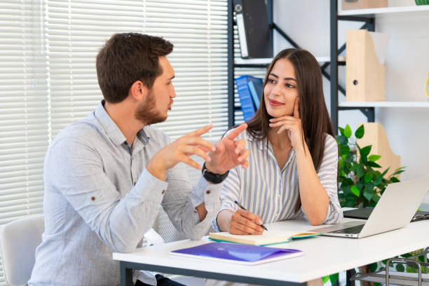 istock Two business people working together in office 1744957682